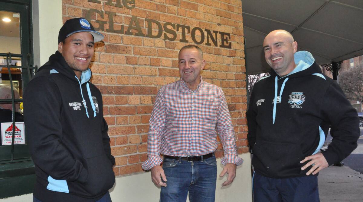 LOCKED IN: Willie Heta, pictured with the Gladstone's Brett Syphers and Hawks president Mark Johnston, will be at the helm of the two blues until at least the end of 2020. 
