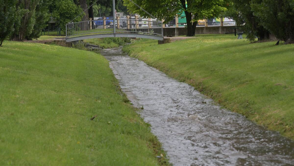 WATER WORKS: The channel through Matthews Park was running following Friday afternoon storm in Orange. Photo: JUDE KEOGH