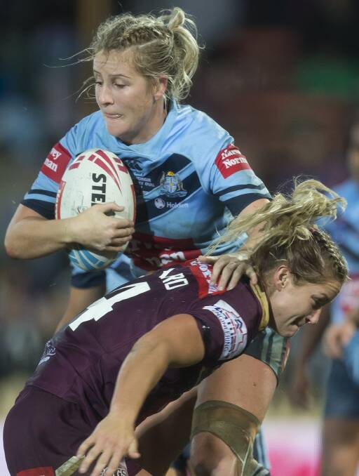 BANG: Talesha Quinn tries to fend past Queensland centre Meg Ward. Photo: AAP