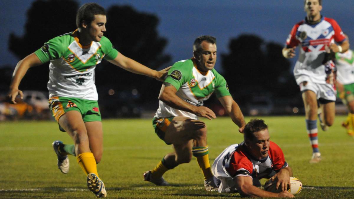 KNOCKOUT OUT: Sam Jones and Scott Sullivan try to stop this try against the Wagga Kangaroos in the 2015 West Wyalong Knockout final. 