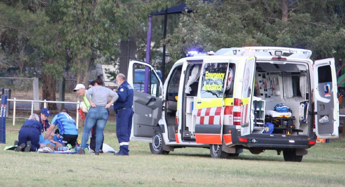 INJURED: Cargo half Matt Clarke is attended to by ambulance staff after suffering a badly broken leg on Sunday. Photo: CARGO BLUE HEELERS