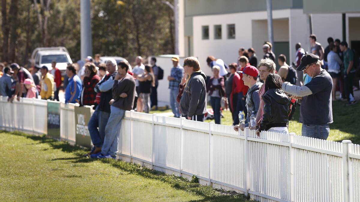 LINING UP: Parents line-up along fences at junior sporting fields across the country. Photo: FILE