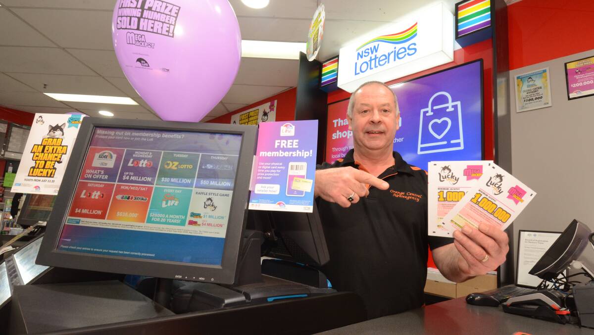 PRIZE: Gary Allen, who runs the Orange Central Newsagency with wife Jennifer, celebrates the customer's lottery win. Photo: JUDE KEOGH