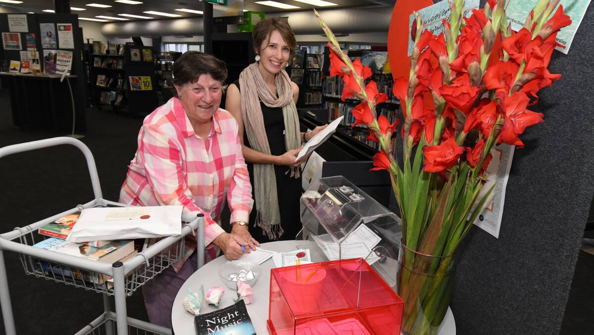 LOVE OF WORDS: Robyn Wallace and Bek Salmon are asking people to join in on Library Lovers Day theme of "Uncover something new" in 2020. Photo: JUDE KEOGH 