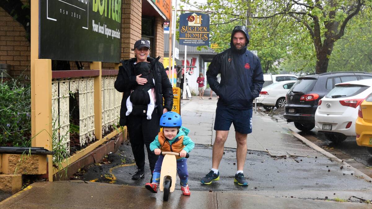 RIDING IN THE RAIN: Floss, Hugo, Freddie and Tim Jones out on Sunday in Orange as the rain continue to fall. Photo: CARLA FREEDMAN