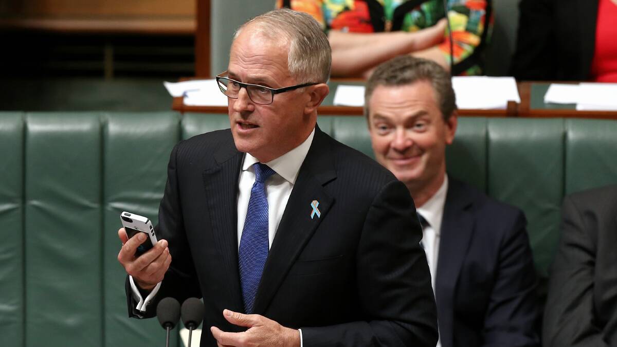 CAN IT: Mobile phone use in public places is annoying, intrusive, unbecoming and downright rude and, Denis Gregory writes, it should be considered the same in federal Parliament, where Malcolm Turnbull can be seen pictured with a phone in 2014. Photo: AAP