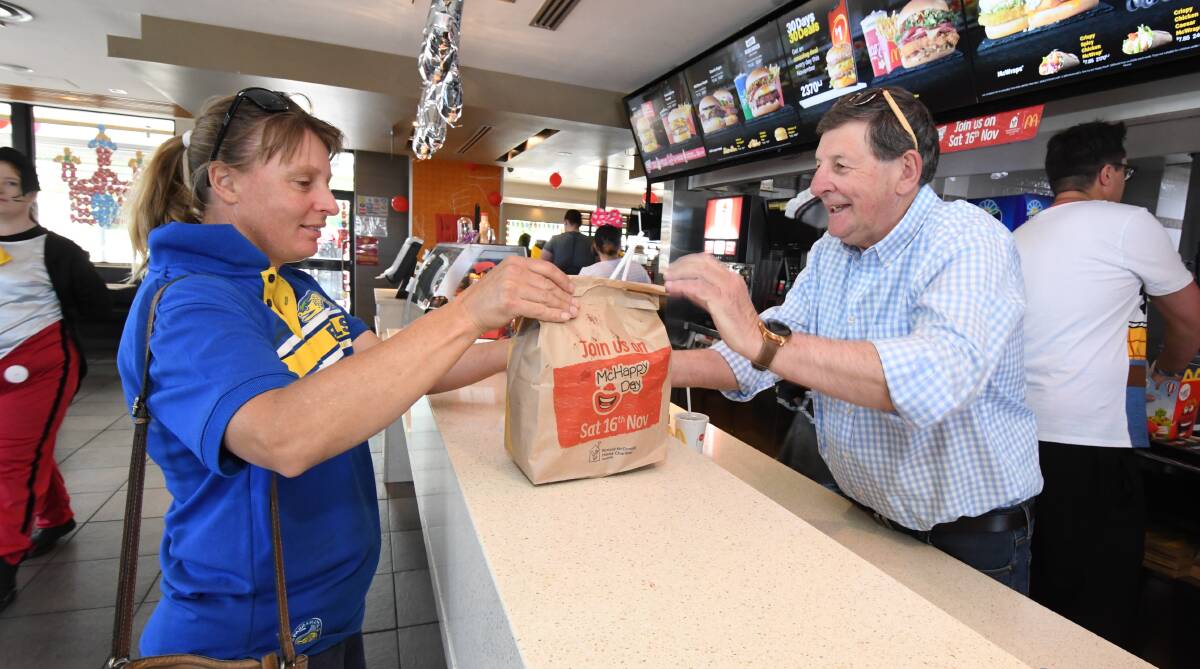 THANKS, REG: Amanda Wiegold receives her Big Mac from Orange mayor Reg Kidd during McHappy Day on Saturday. Photo: JUDE KEOGH