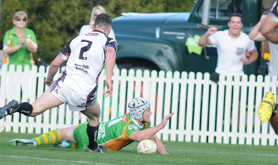 Tim Bassmann scores a try for Orange CYMS in the 2015 Group 10 grand final, with Daniel Mortimer cheering on in the background. Picture by Steve Gosch