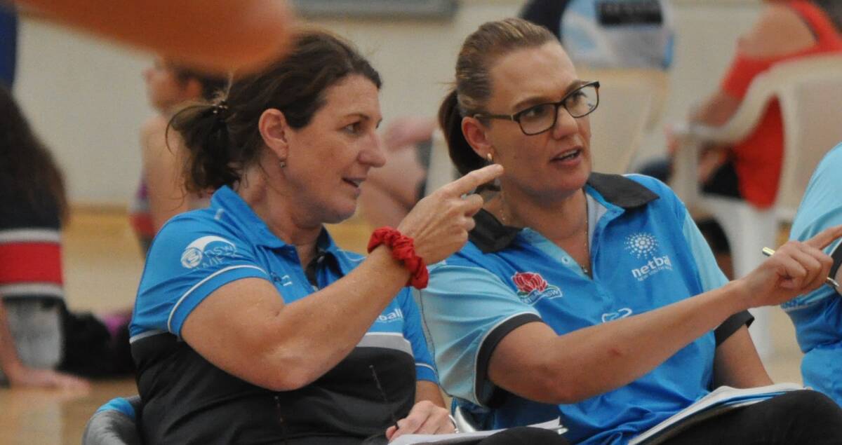 LOOK AT THAT: Marianne McCormick talks tactics with the coaching staff of the NSW under 19s team. Photo: NICK McGRATH