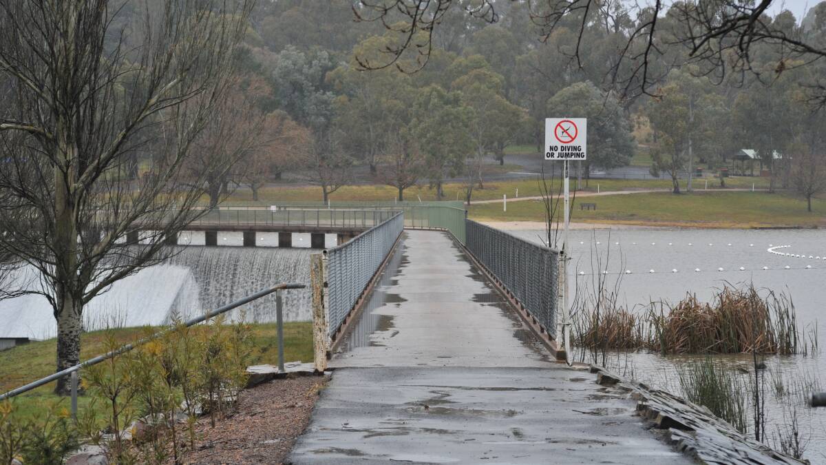 OVER SHE GOES: Water spills over a very wet Lake Canobolas wall on Sunday. We've endured our wettest July in 31 years. Photo: CARLA FREEDMAN