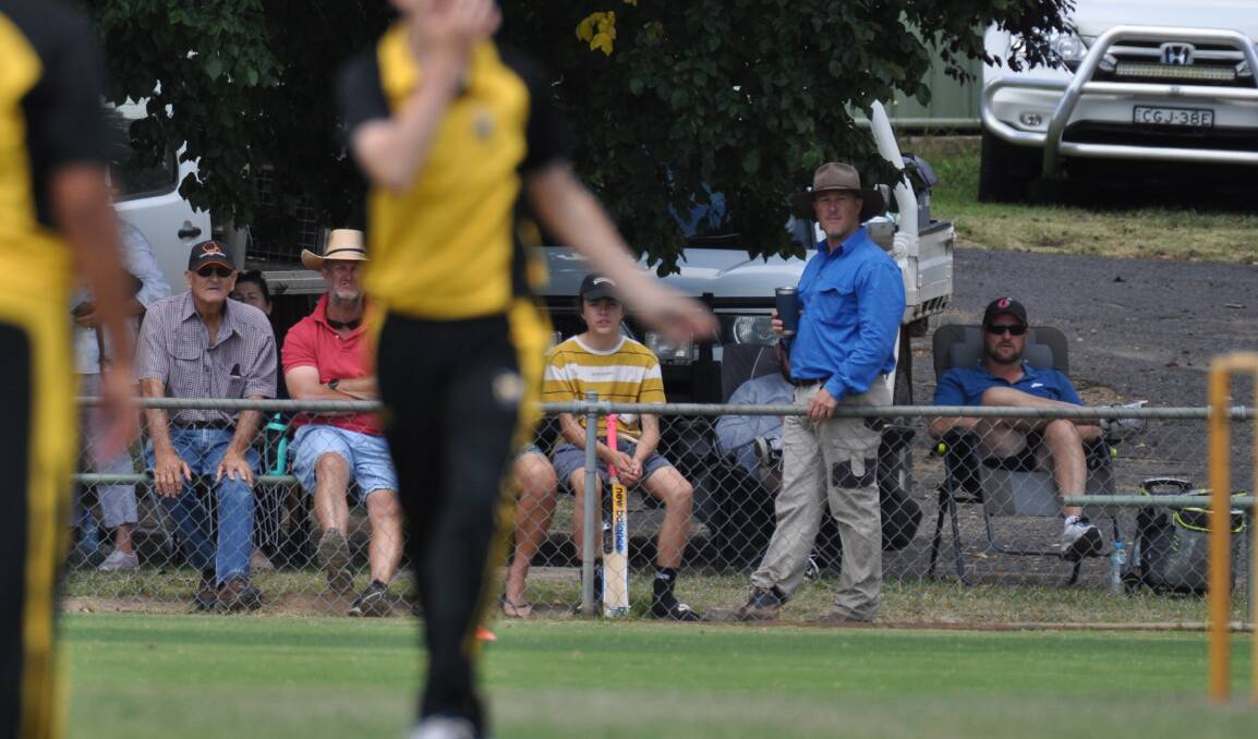 TIRED: Spectators at Sunday's junior grand final lean on the old fence at Riawena Oval. An upgrade of the perimetre fence is on the cards. Photo: NICK McGRATH