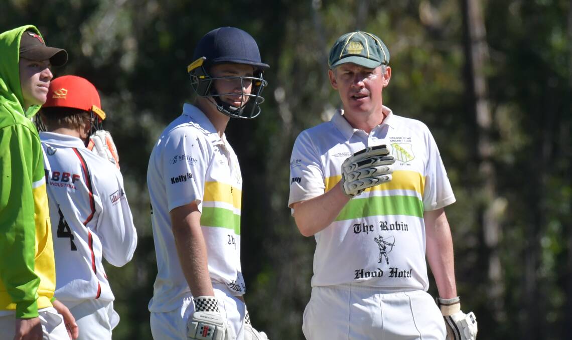 WISE OLD BAT: CYMS veteran Dave Neil gives young willow wielder Tom West a tip or two during the green and golds' last round victory over Centrals. Photo: JUDE KEOGH
