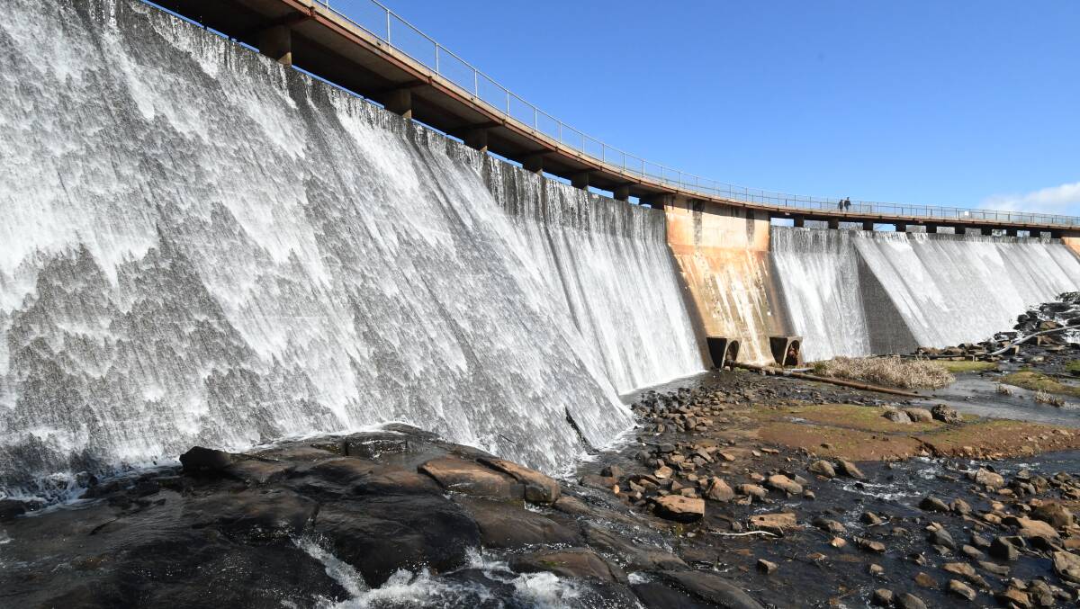 SPILL: Water flows over the wall at Lake Canobolas, Orange's total water storage is headed to 40 per cent. Photo: CARLA FREEDMAN