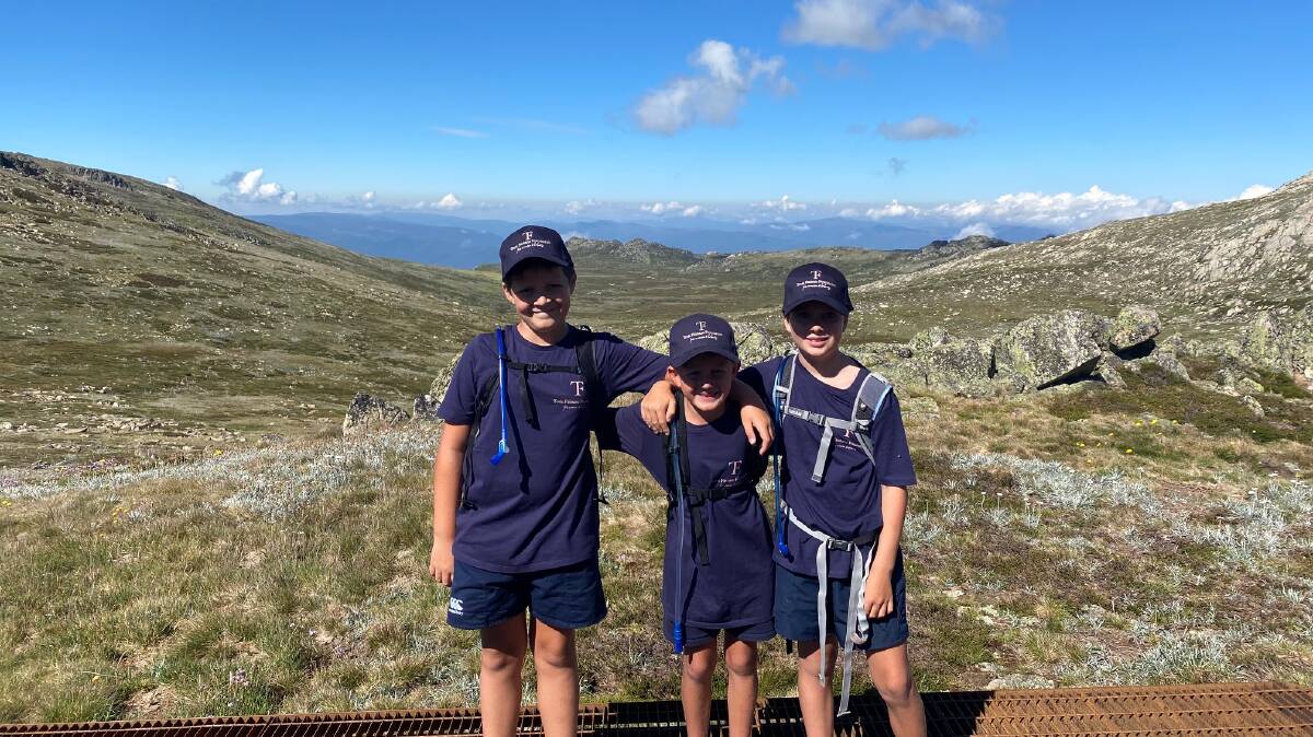 From left, Finn Gibson (10), Ollie Finnane (6) and Ted O'Hare (8) on top of Mount Kosciuszko. Photo: CONTRIBUTED