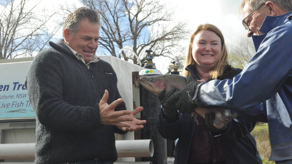 Member for Orange Phil Donato lends a hand as Minister NSW Minister for Agriculture Tara Moriarty latches on to this rainbow trout. Picture by Nick McGrath