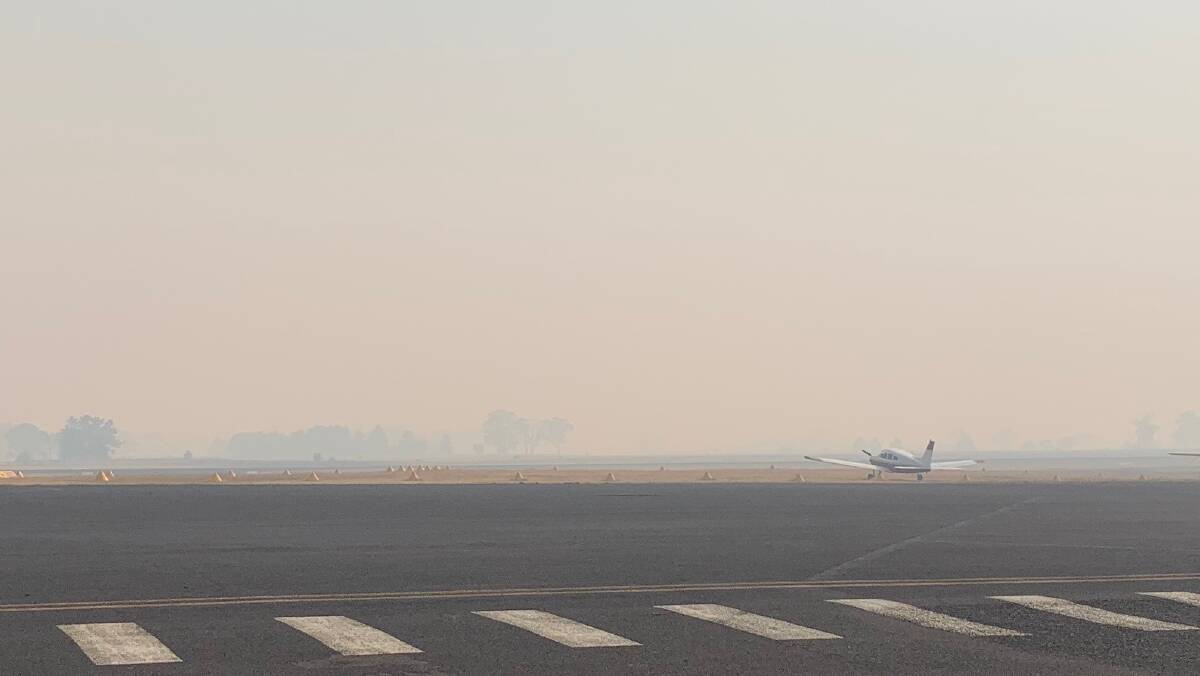 DELAYS: Flights to Sydney and Melbourne are being delayed as authorities wait for the smoke blanket covering the city to disperse. Photo: TRACEY PRISK