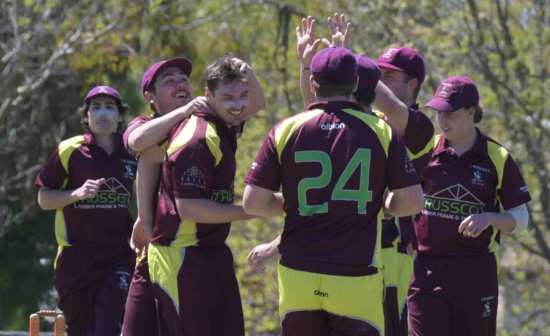 GET AROUND HIM: Cavaliers celebrate a wicket at Riawena Oval on Saturday. Photo: JUDE KEOGH