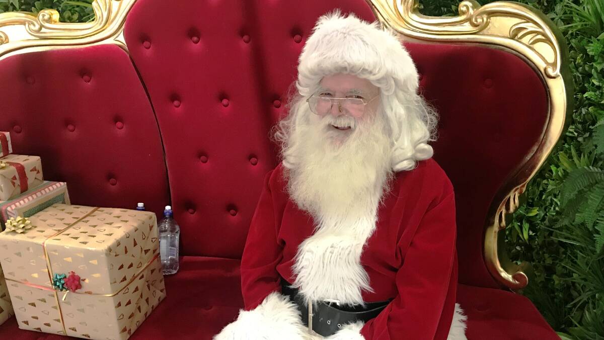 RED AND REAL: Santa Claus at Orange City Centre brightens the day for dozens of kids. Try telling them hes not real.