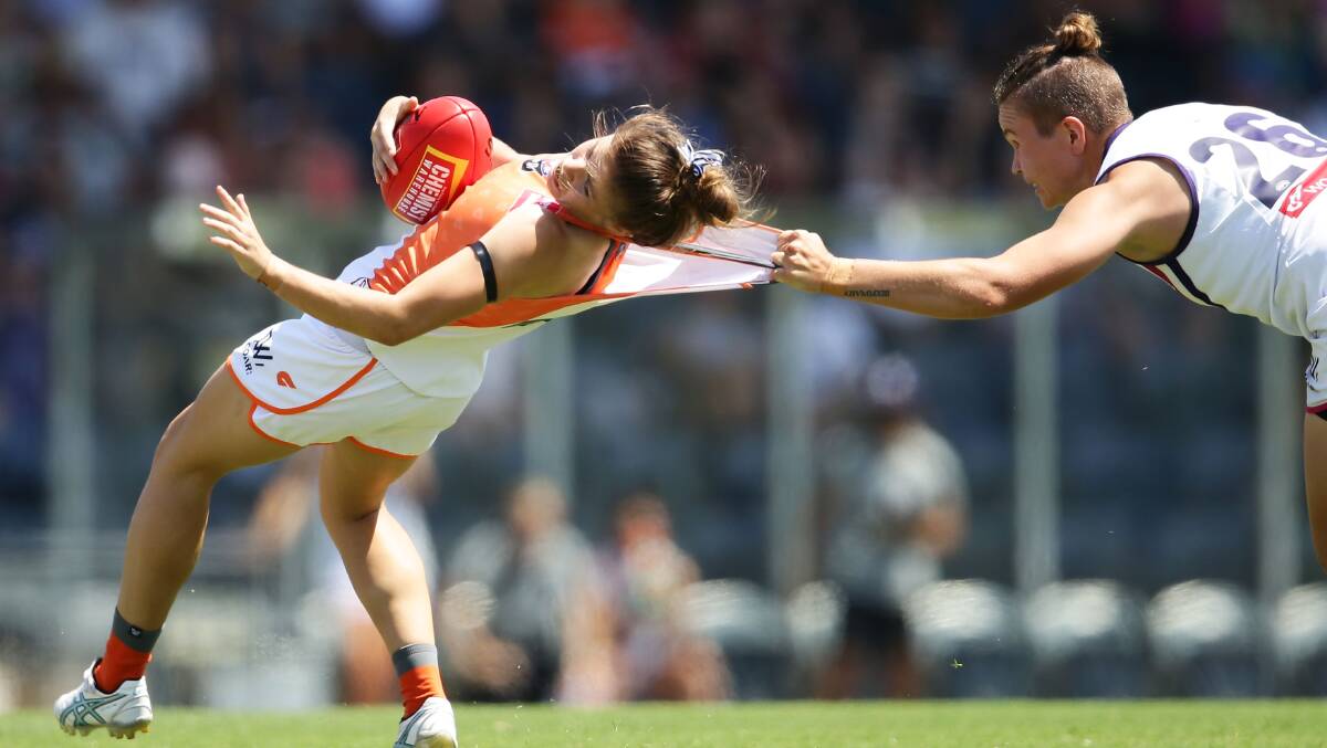 NOT SO FAST: Stephanie Walker is rag-tagged by Taylah Angel during an AFL women's clash. Photo: GETTY IMAGES