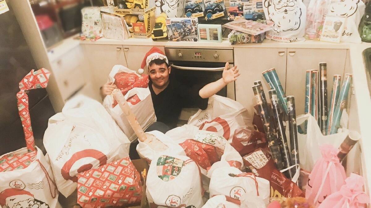 HO HO HO: Jason Owen spent much of last November and December wrapping and delivering Christmas presents to kids across the Central West. Photo: CONTRIBUTED