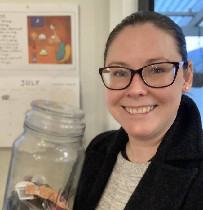 NO PLASTIC: Kate Willoughby holding a jar containing the total amount of plastic she has used in the past month. Photo: CONTRIBUTED