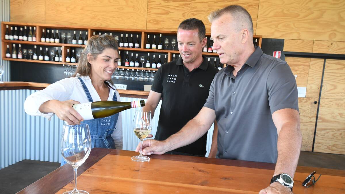 TIME FOR A WINE: Nashdale Lane winery's Tanya and Nick Segger alongside Getaway presenter David Reyne. Photo: JUDE KEOGH