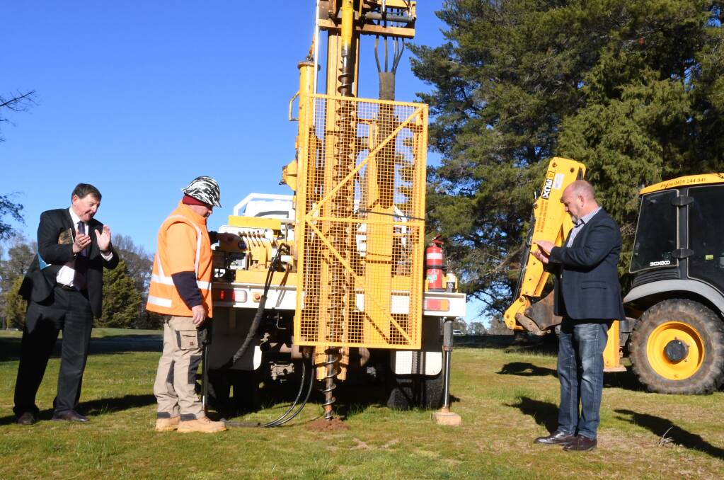 WORK BEGINS: Orange mayor Reg Kidd and councillor Jason Hamling watch on as drilling at the new sporting precinct site commences. Photo: JUDE KEOGH