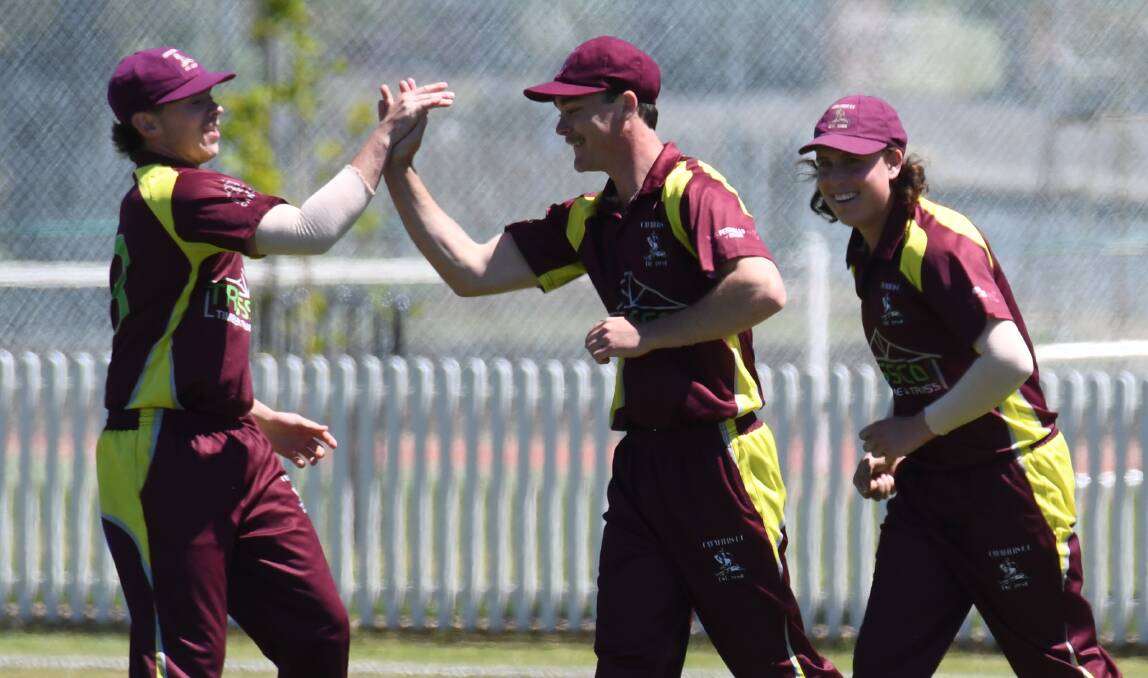Cavaliers players get around Bailey Ferguson after a wicket falls in his side's win over City Colts at Wade Park. Photo: JUDE KEOGH