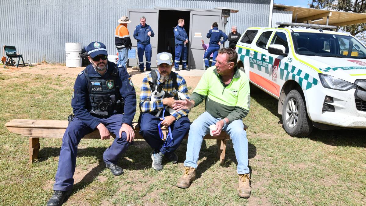 Senior Constable James Paul, Joel Neville, Bandit, Peter Jones during Prime Minister Anthony Albanese and Premier Dom Perrottet visit to Eugowra on Tuesday. Picture by Carla Freedman.