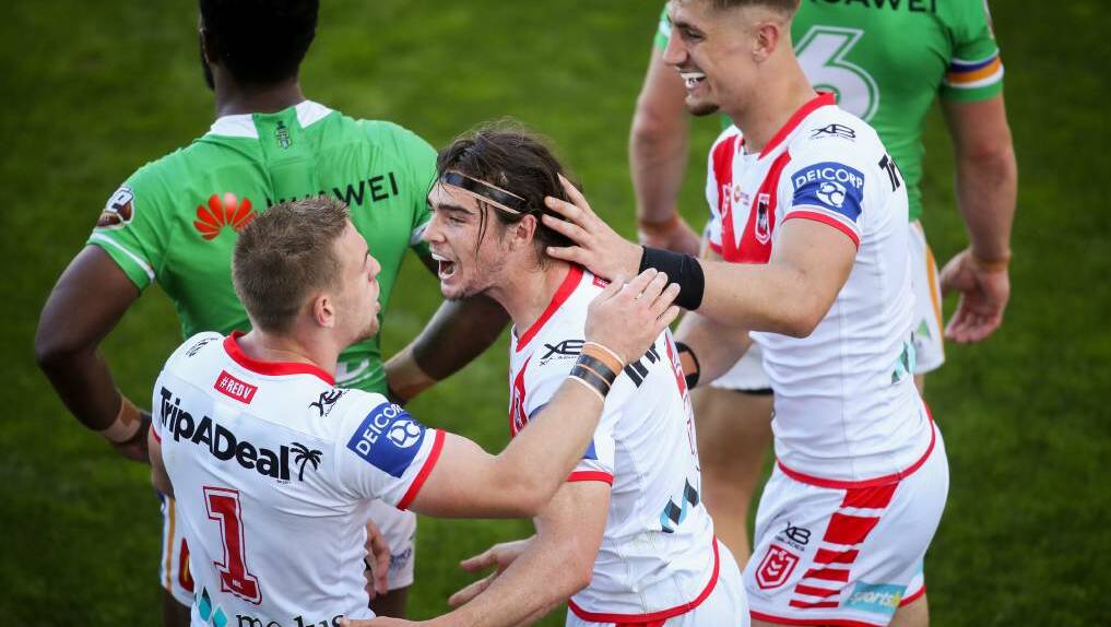 DEBUT: Cody Ramsey is mobbed after scoring on debut for the Dragons. Photo: ILLAWARRA MERCURY