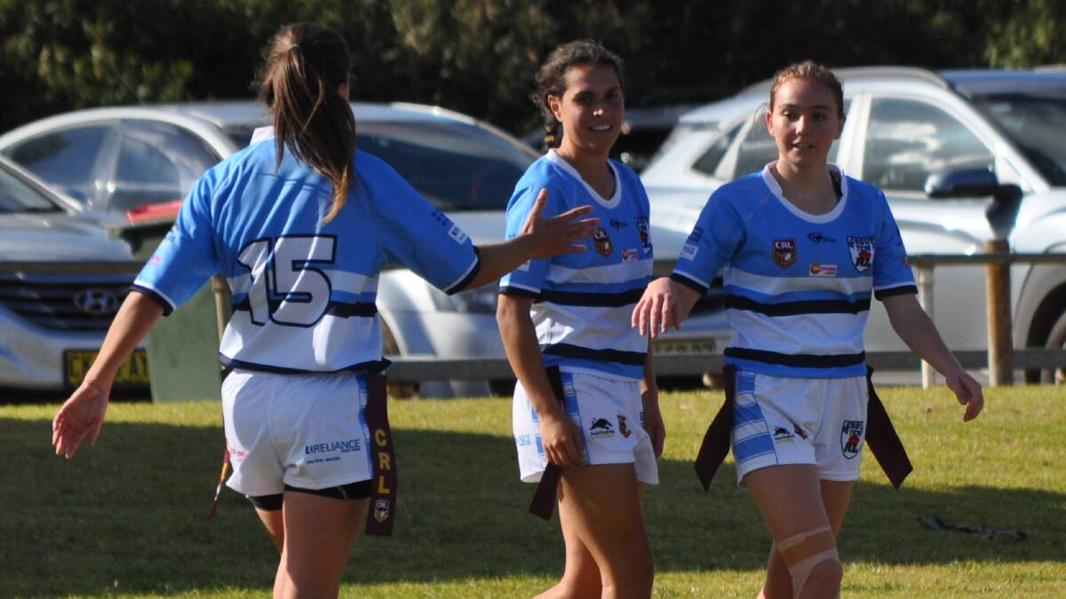 WELL DONE: Group 10 guns Jes Pearson (right) and Erin Naden (middle) are congratulated by Bec Ford after one of Pearson's tries on Saturday. Photo: NICK McGRATH