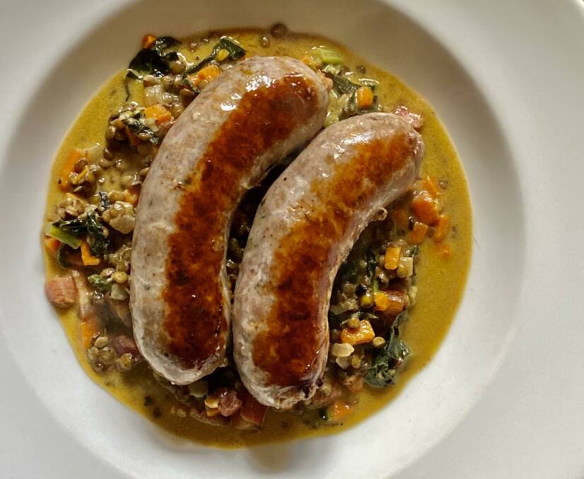 TASTY: Made in Orange Cumberland Sausages with Blue Lentils, Cavalo Nero and Mustard Butter Sauce.