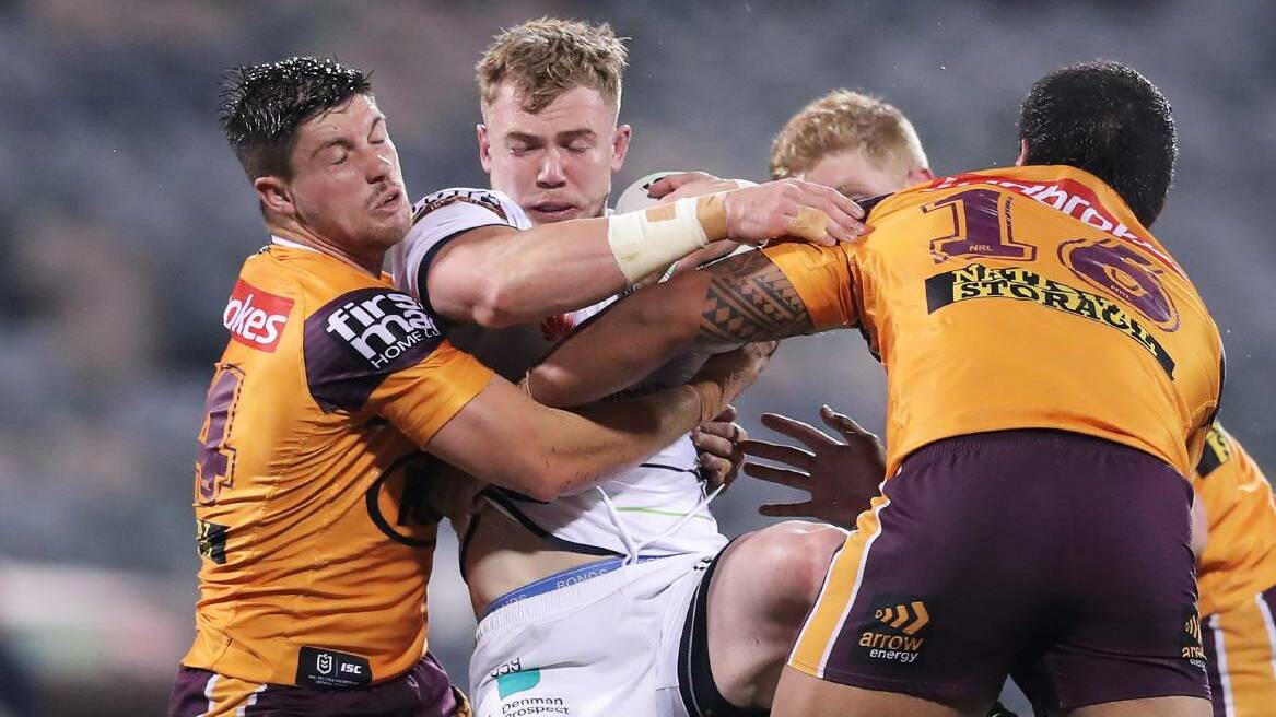 WHY IS SPORT EXEMPT: Raiders' forward Hudson Young is tackled by the Broncos players in their NRL clash in Canberra. Picture: Elesa Kurtz.