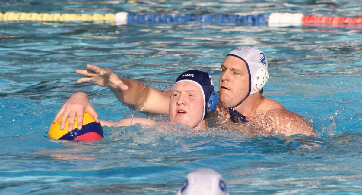 BIG MAN BATTLE: Digby Cooper from Team Platypus tries to protect the ball from Phar Laps' Rob Thorburn. Photo: MICHELLE COOK 1217mcwpolo1