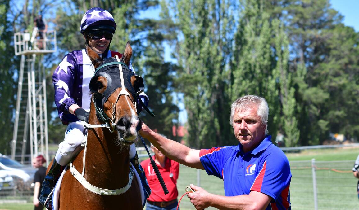 GOOD TIMES: Trainer Dean Mirfin (right) brings Kind Reward back to the yard after Friday's victory. Photo: BRADLEY JURD
