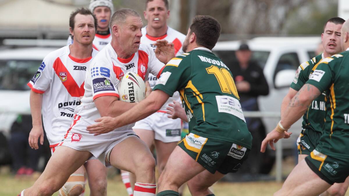 UP FRONT: Rhinos skipper Simon Osborne charges the ball forward during Sunday's grand final. RS WILLIAMS