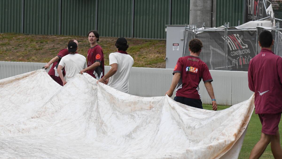 PUT THEM ON, BOYS: Cavaliers players spent as much time working the covers as they did out on the middle at Wade Park on Saturday. Photo: JUDE KEOGH