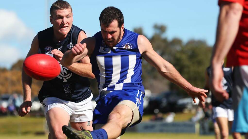 CAPPED: Temora midfielder Kieran Shea gets a kick in just before Coleambally's Tom Morton arrives in the Farrer League, where there's both a points and salary cap. Photo: DAILY ADVERTISER