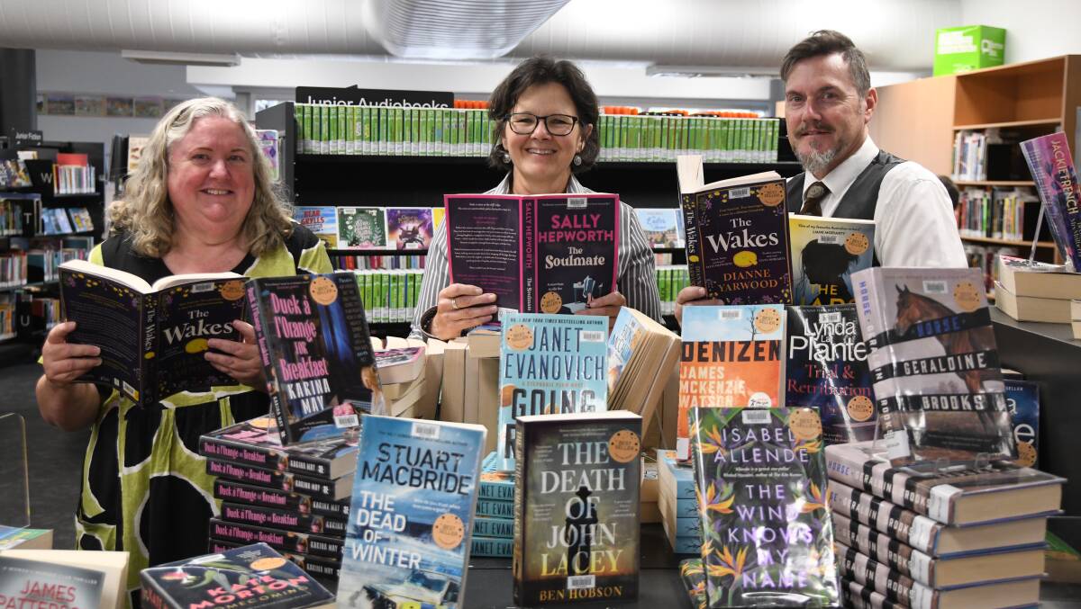 Roslyn Cousins, Monica Engel, Sean Brady with some of the most read books of 2023 at Orange City Library. Picture by Carla Freedman