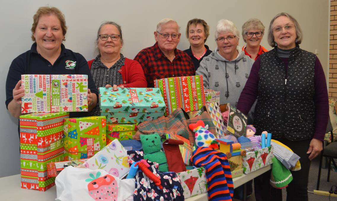 VOLUNTEERS: Jenny Abbott, Hazel King, Leon Willis, Robyn Hicks, Elizabeth Kay, Pam Green and Emma Baker with some of the boxes they will give to children. 