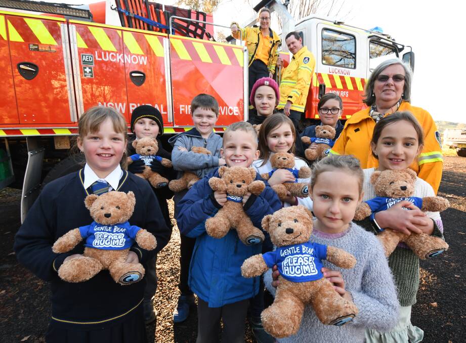 COMFORTING: Katrina Smith, Adrian Cisco, Callum Cisco, Eli and Emilia Selwood, Cooper Smith, Barb Bloomfield, Rachel and Connor Bloomfield, Abby Cisco, Caityn and Hallie Long with the Gentle Bears. Photo: JUDE KEOGH
