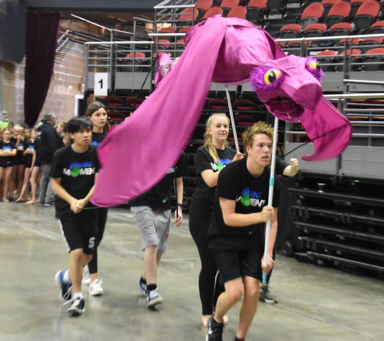 ON SITE REHEARSAL: Good team work is the key for Orange High School drama students maneuvering a giant creature in the Schools Spectacular. Photo: GRANT HATCH