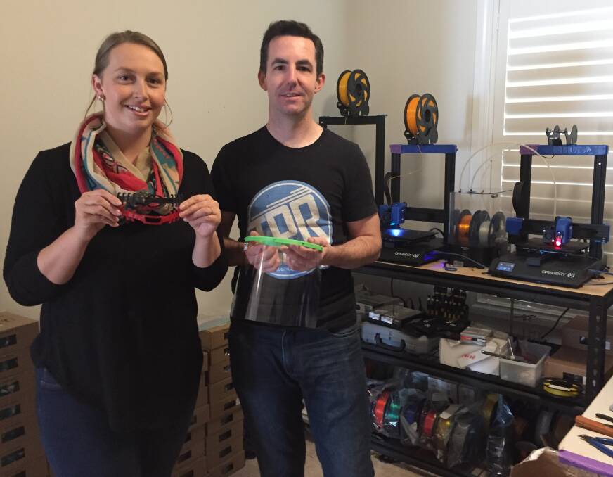 SUPPLY: Lara and Chris Preen from TPR Engineering with ear protectors and a face shield that have been made with 3D printers for health workers. Photo: TANYA MARSCHKE