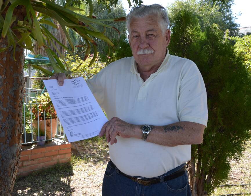 NOT HAPPY: Parkes resident Tim Holt with the letter he was sent by a staff member from Orange City Council about the flying foxes. Photo: BARBARA REEVES