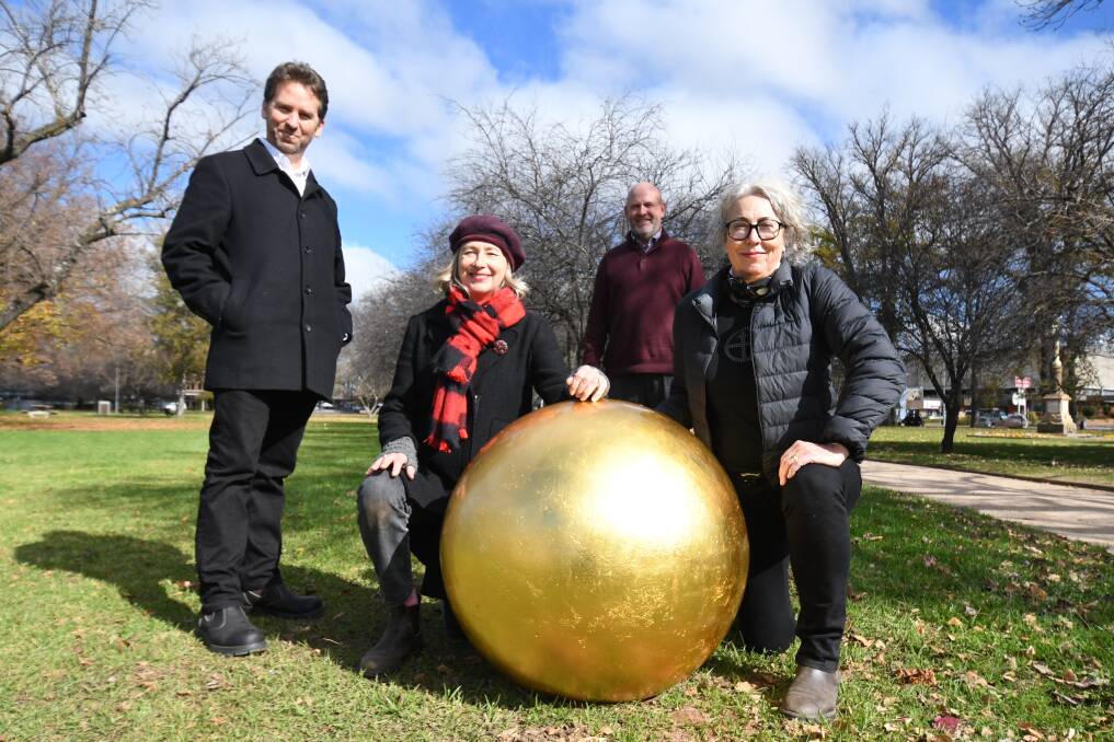 PUBLIC ART: Brad Hammond,Lisa Jones, Mayor Jason Hamling, Julia Davis with one of the spheres. Photo: JUDE KEOGH