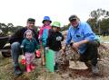 TREE PLANTING: Rob, Piper, Letty and Penny Tierney learn to plant a tree from Bill Josh. Photo: CARLA FREEDMAN
