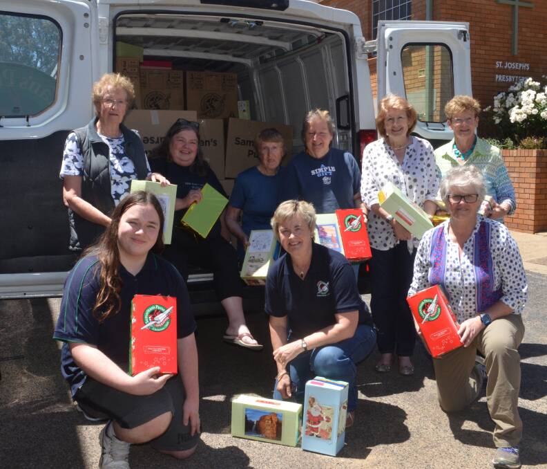 GOOD SAMARITANS: Megan Crawford, driver Kirsty Georgans, Marj Strong, Jenny Abbott, Robyn Wright, Jenny Maher, front, Matthew Georgans, Robyn Hicks, Pam Green with the truck load of gifts.