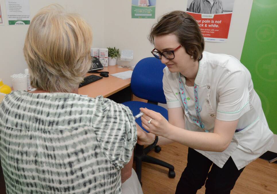FLU PREVENTION: Karen Blom receives her flu vaccination from McCarthy's Pharmacy pharmacist in charge Annika Rookyard. Photo: JUDE KEOGH