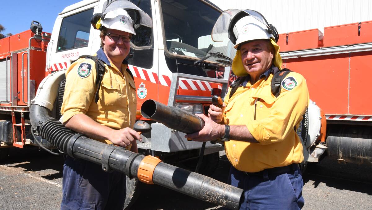 FIRE CONTROL: Mitigation crew leader Kieran Scouller and crew member Harold Rossiter with air blowers. Photo: JUDE KEOGH