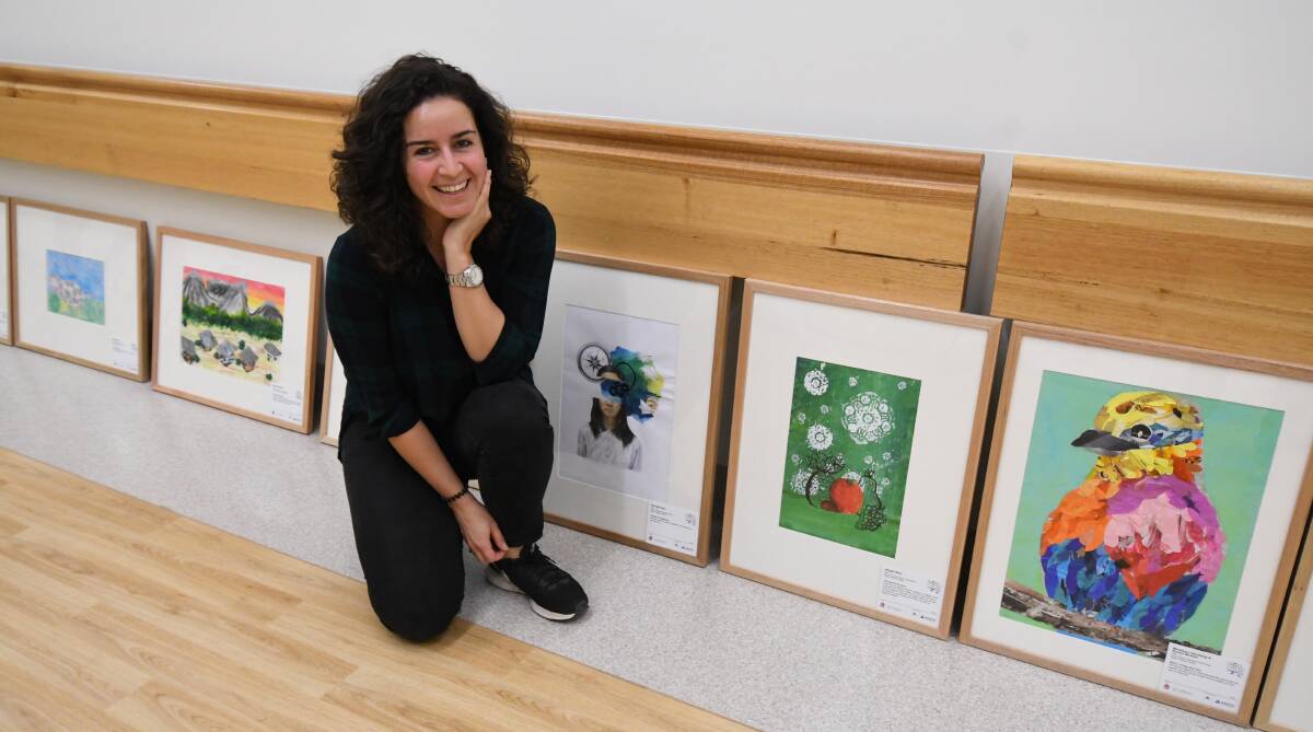 CREATIVE KIDS: Orange Regional Gallery curator Lucy Joseph with some of the works that are displayed at the Orange hospital. Photo: JUDE KEOGH